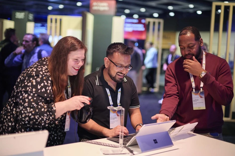 A group of people looking at a laptop