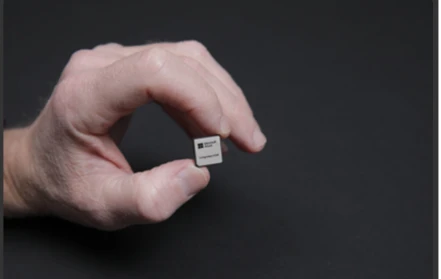 A hand holding Azure Integrated HSM, a security chip.